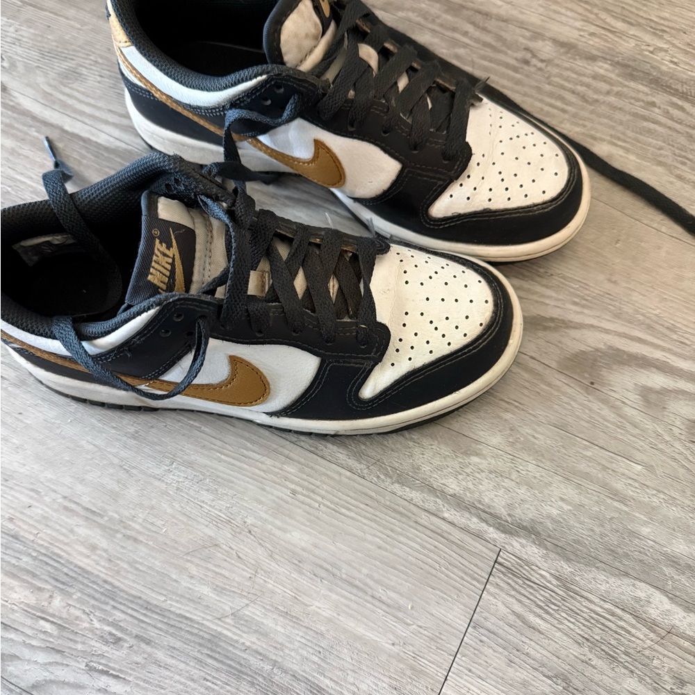 Nike kids Black, White, and Gold Sneakers